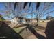 Large backyard with mature trees and a view of the house at 1025 E Kerry Ln, Phoenix, AZ 85024