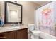 Bathroom with granite vanity and pig shower curtain at 10506 W Pasadena Ave, Glendale, AZ 85307