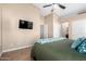 Spacious bedroom with a queen bed, TV, and ample closet space at 10506 W Pasadena Ave, Glendale, AZ 85307