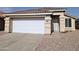 Front view of a single story home with a white garage door at 10506 W Pasadena Ave, Glendale, AZ 85307