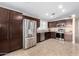 Modern kitchen with stainless steel appliances and dark wood cabinets at 10506 W Pasadena Ave, Glendale, AZ 85307