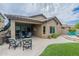 Backyard features a covered patio, fire pit and lush landscaping at 10834 W Swayback Pass, Peoria, AZ 85383