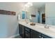 Double vanity bathroom with modern fixtures and a large mirror at 10834 W Swayback Pass, Peoria, AZ 85383