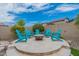 Enjoy the outdoors around this firepit with teal chairs at 10834 W Swayback Pass, Peoria, AZ 85383