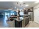 Open kitchen with island, stainless steel appliances, and view to dining area at 10834 W Swayback Pass, Peoria, AZ 85383