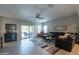 Living room with sectional sofa, large windows, and access to patio at 10834 W Swayback Pass, Peoria, AZ 85383