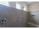 Large walk-in shower with gray tile and built-in bench seating at 10834 W Swayback Pass, Peoria, AZ 85383