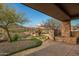 Landscaped backyard with stone features and desert plants at 10962 E Old Trails Rd, Scottsdale, AZ 85262