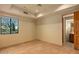 Bedroom with window, ceiling fan and access to bathroom at 10962 E Old Trails Rd, Scottsdale, AZ 85262