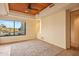 Bright bedroom with large window and wood ceiling at 10962 E Old Trails Rd, Scottsdale, AZ 85262