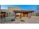 Front entrance of a beautiful home with stone accents and desert plants at 10962 E Old Trails Rd, Scottsdale, AZ 85262