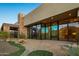 Contemporary home exterior featuring stone and large windows at 10962 E Old Trails Rd, Scottsdale, AZ 85262