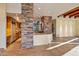 Kitchen with stone accents, island, and wood cabinetry at 10962 E Old Trails Rd, Scottsdale, AZ 85262