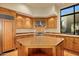 Kitchen boasts a large island and wood cabinets at 10962 E Old Trails Rd, Scottsdale, AZ 85262