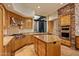 Kitchen with island, double ovens, and wood cabinets at 10962 E Old Trails Rd, Scottsdale, AZ 85262