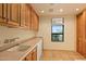 Laundry room with sink, cabinets, and window at 10962 E Old Trails Rd, Scottsdale, AZ 85262