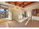 Living room with fireplace, wood beams, and large windows at 10962 E Old Trails Rd, Scottsdale, AZ 85262