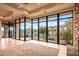 Living room with wall of windows showcasing scenic views at 10962 E Old Trails Rd, Scottsdale, AZ 85262