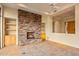 Living room with a large stone fireplace and built-in shelves at 10962 E Old Trails Rd, Scottsdale, AZ 85262