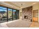 Spacious living area with a stone fireplace and large windows at 10962 E Old Trails Rd, Scottsdale, AZ 85262