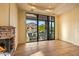 Living room features a stone fireplace and large windows at 10962 E Old Trails Rd, Scottsdale, AZ 85262