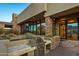 Outdoor kitchen with stainless steel grill and stone countertops at 10962 E Old Trails Rd, Scottsdale, AZ 85262