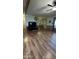 Living room with hardwood floors, TV, and Christmas tree at 11596 W Sierra Dawn Blvd # 105, Surprise, AZ 85378