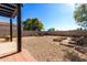 Landscaped backyard with fire pit and seating area at 13185 W Calavar Rd, Surprise, AZ 85379