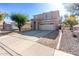 Two story home with attached garage and landscaped yard at 13185 W Calavar Rd, Surprise, AZ 85379