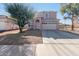 Two-story house with attached garage and landscaping at 13185 W Calavar Rd, Surprise, AZ 85379