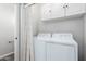 Bright laundry room with washer, dryer, and overhead cabinets at 13185 W Calavar Rd, Surprise, AZ 85379