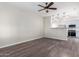 Living room with hardwood floors and ceiling fan at 13185 W Calavar Rd, Surprise, AZ 85379