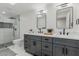 Modern bathroom with double vanity and walk-in shower at 13223 W Gaucho Dr, Sun City West, AZ 85375