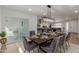 Modern dining room with a large table and view of the kitchen at 13223 W Gaucho Dr, Sun City West, AZ 85375