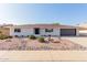 House exterior with a dark garage door and landscaping at 13223 W Gaucho Dr, Sun City West, AZ 85375