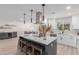 Modern kitchen with white cabinets and a large island at 13223 W Gaucho Dr, Sun City West, AZ 85375