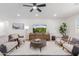 Bright living room featuring comfortable seating and a large TV at 13223 W Gaucho Dr, Sun City West, AZ 85375