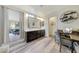 Spacious bathroom featuring a double sink vanity, modern lighting, and a door at 13235 W Tether Trl, Peoria, AZ 85383