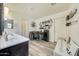 Bright bathroom featuring a vanity with a sink and desk area at 13235 W Tether Trl, Peoria, AZ 85383