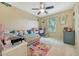 Charming bedroom featuring whimsical wall decor, plush bedding, and a bright, airy window at 13235 W Tether Trl, Peoria, AZ 85383