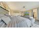 Bedroom featuring a gray upholstered bed, sofa, and a view of the TV screen at 13235 W Tether Trl, Peoria, AZ 85383