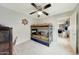 Bedroom featuring a fan, bed, and view through doorway into a living space at 13235 W Tether Trl, Peoria, AZ 85383