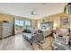 Well-lit bedroom with a queen-sized bed, gray sofa, and large windows at 13235 W Tether Trl, Peoria, AZ 85383