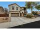 Two-story home with a two car garage, neutral stucco, manicured landscaping, and charming architectural details at 13235 W Tether Trl, Peoria, AZ 85383