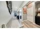 Bright hallway with wood-look flooring, a bench, and decorative wall art at 13235 W Tether Trl, Peoria, AZ 85383