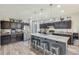 Stylish kitchen with stainless steel appliances, a large center island, and ample counter space at 13235 W Tether Trl, Peoria, AZ 85383