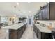 Open-concept kitchen featuring granite countertops, stainless steel appliances and ample counter space at 13235 W Tether Trl, Peoria, AZ 85383