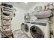 Functional laundry room with modern appliances, ample storage, and convenient shelving at 13235 W Tether Trl, Peoria, AZ 85383