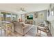 Spacious living room features a large sectional sofa, ceiling fan, and wood-look flooring at 13235 W Tether Trl, Peoria, AZ 85383