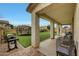 Spacious covered patio with a grill, ample seating, and a view of the lush backyard at 13235 W Tether Trl, Peoria, AZ 85383